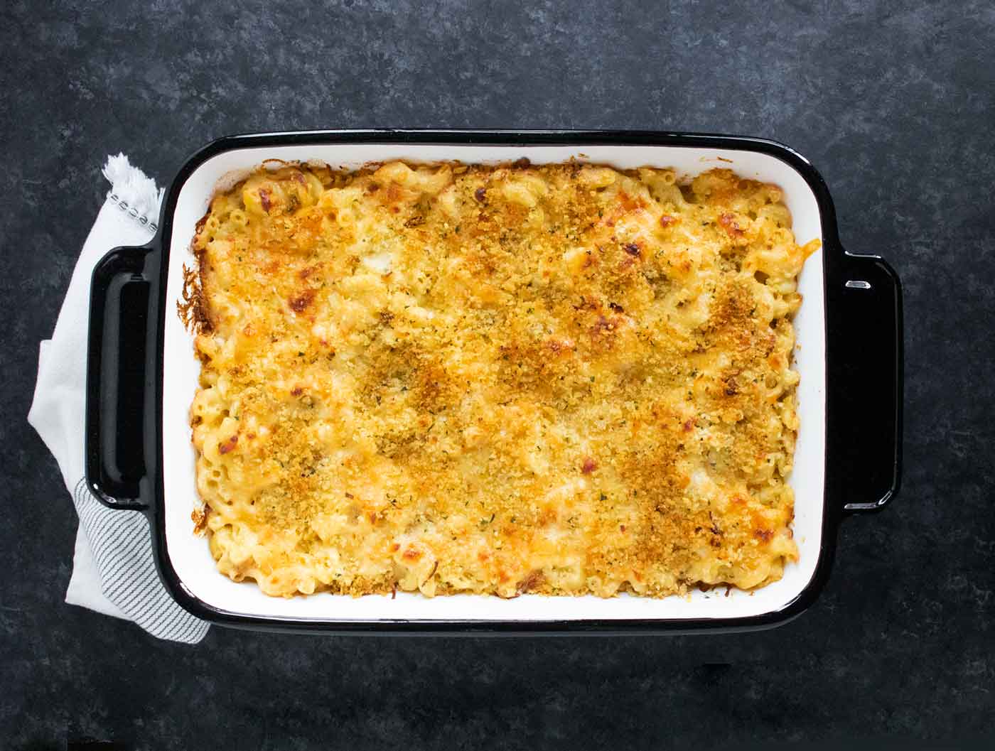 Overhead view of French Onion Mac and Cheese in a white baking pan with black edges.