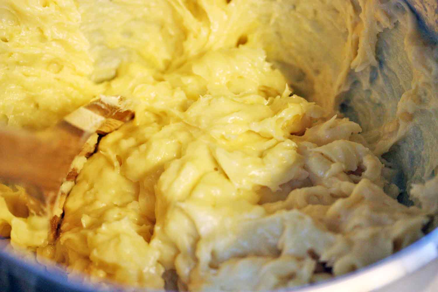 The finished dough in the bowl of a stand mixer.