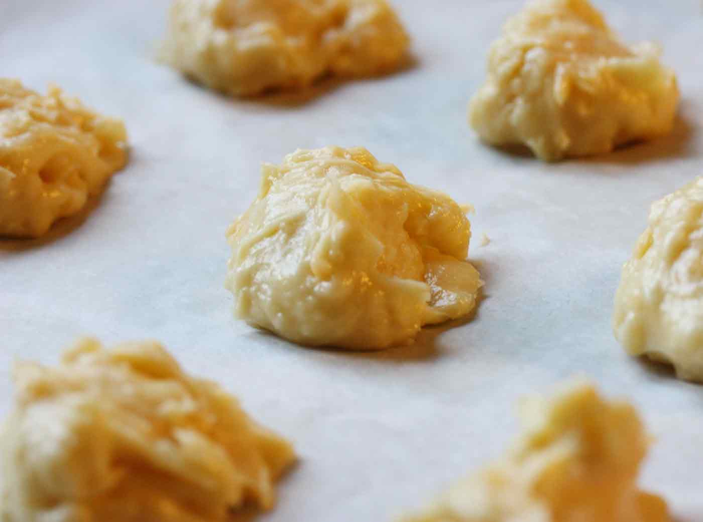 Gougeres spooned onto baking sheets, ready to bake.