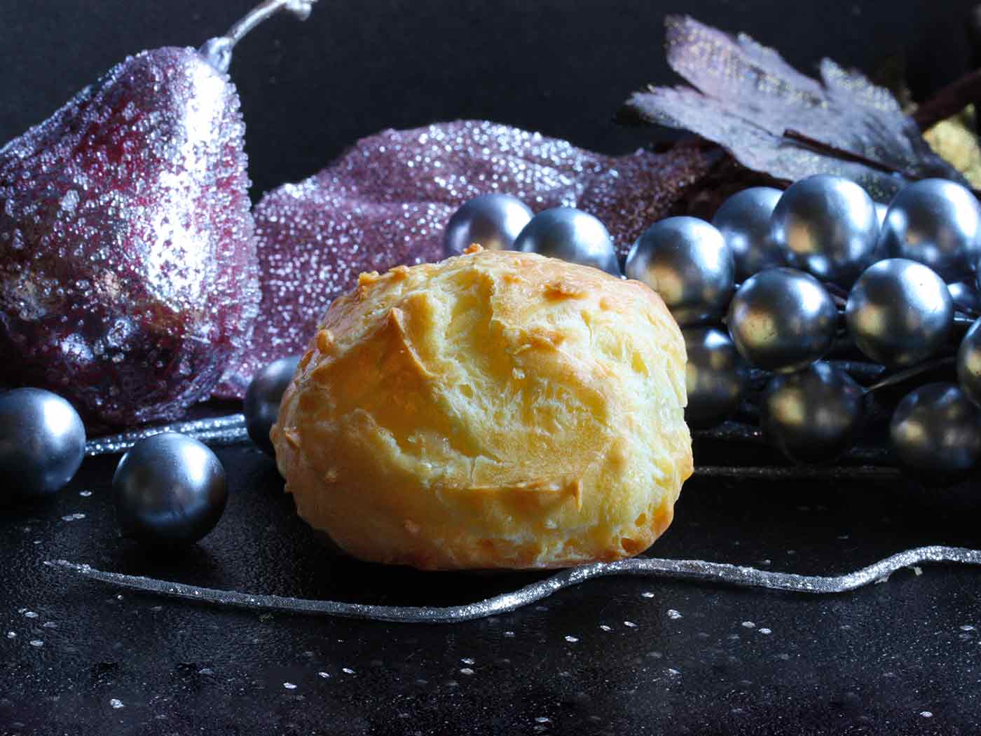 A puffy, cheesy gougere with Christmas decorations.