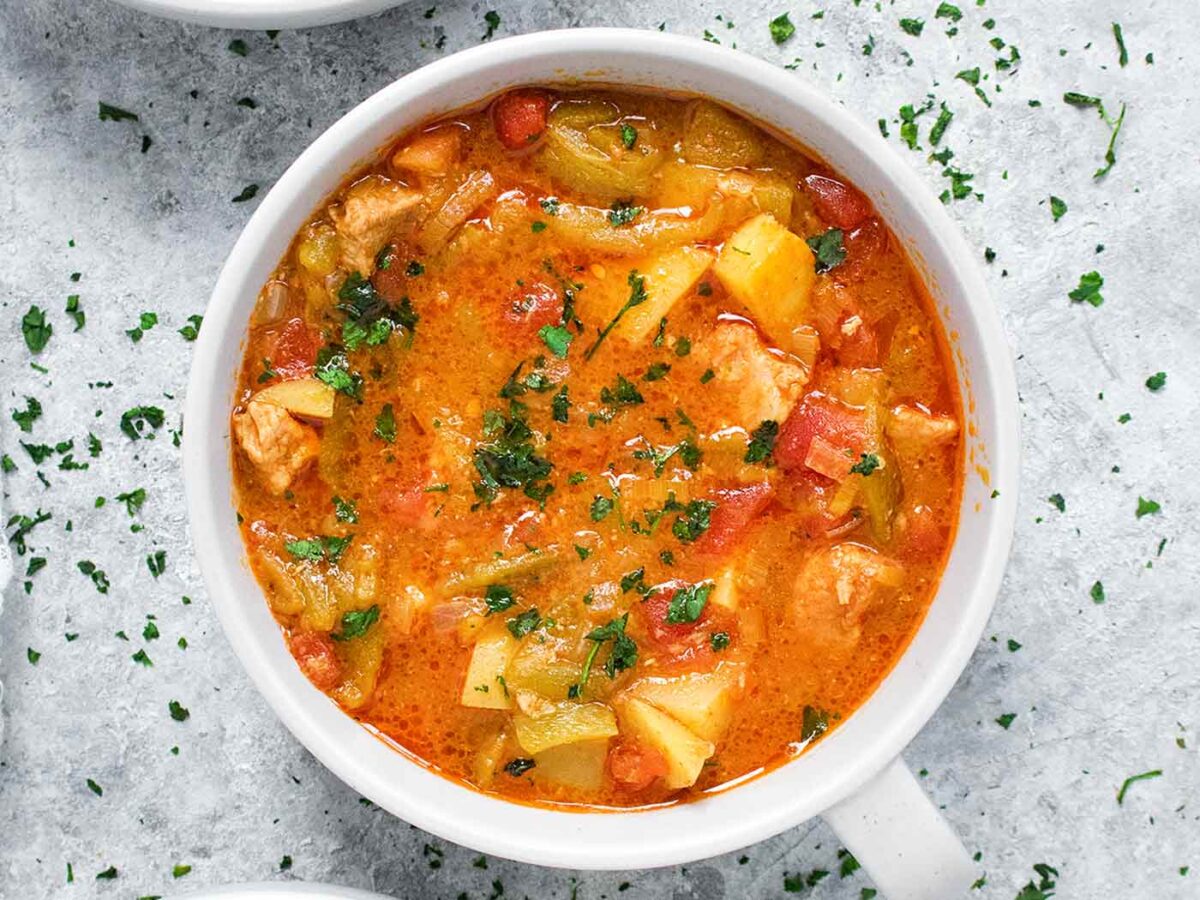 Green Chile Stew in a gray bowl with a handle.