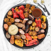 Grilled Sausages, Peppers & Potatoes with mustard and bbq dipping sauces
