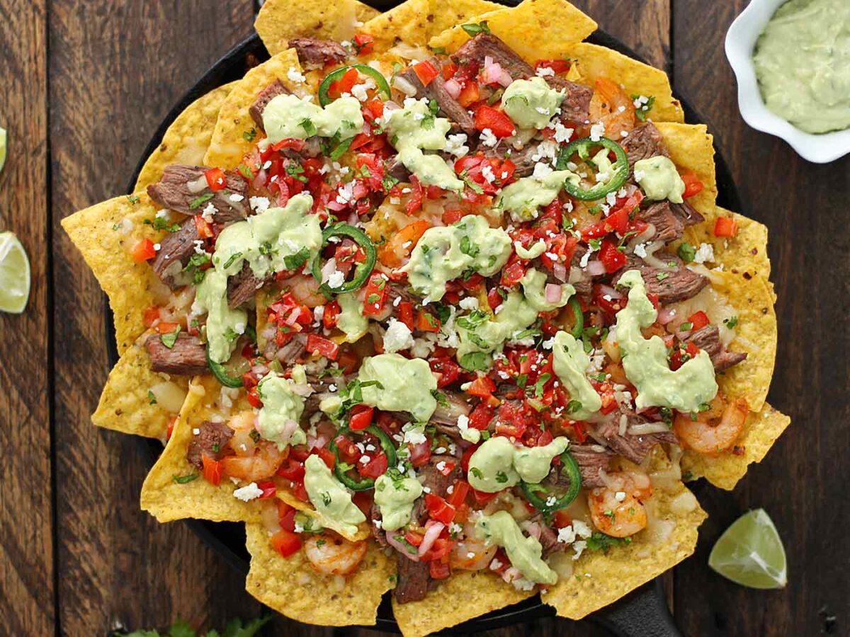 Overhead shot of Grilled Surf n Turf Nachos on a cast iron griddle.