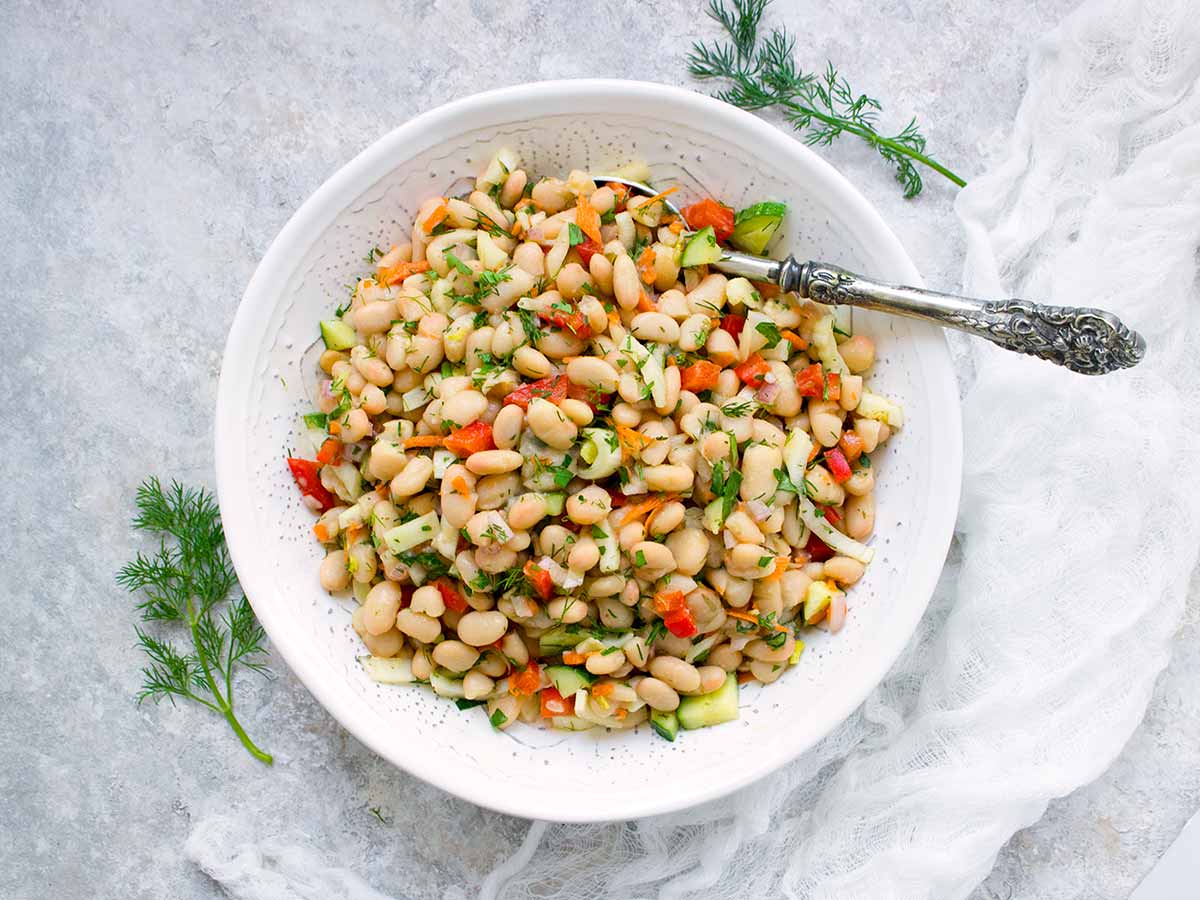 Herbed White Bean Picnic Salad in a large white serving bowl