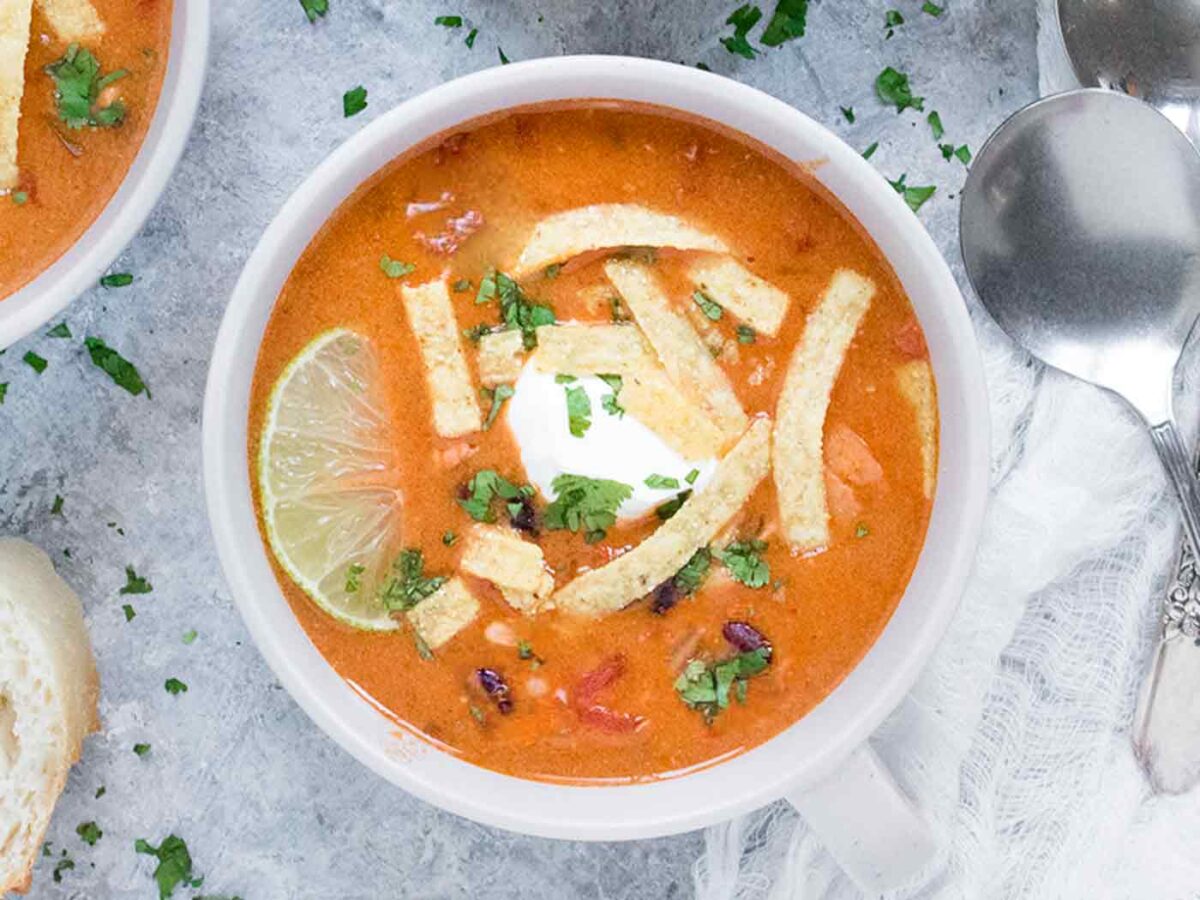 Overhead view of Chicken Tortilla Soup in a light gray mug.