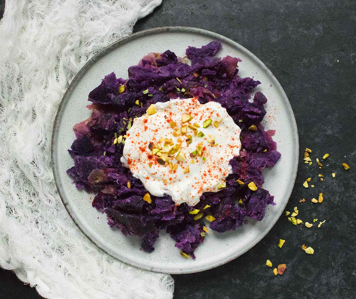 Okinawan Sweet, prepared in a pressure cooker, on a plate topped with creamy coconut milk