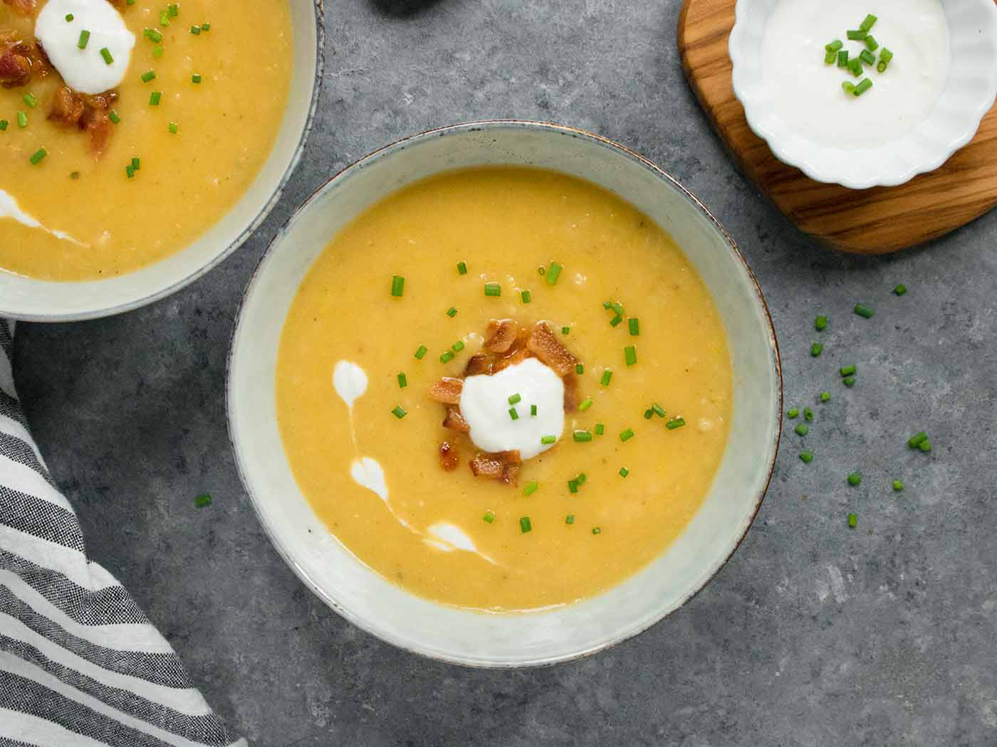 Instant Pot Potato Leek Soup in a bowl topped with horseradish sour cream