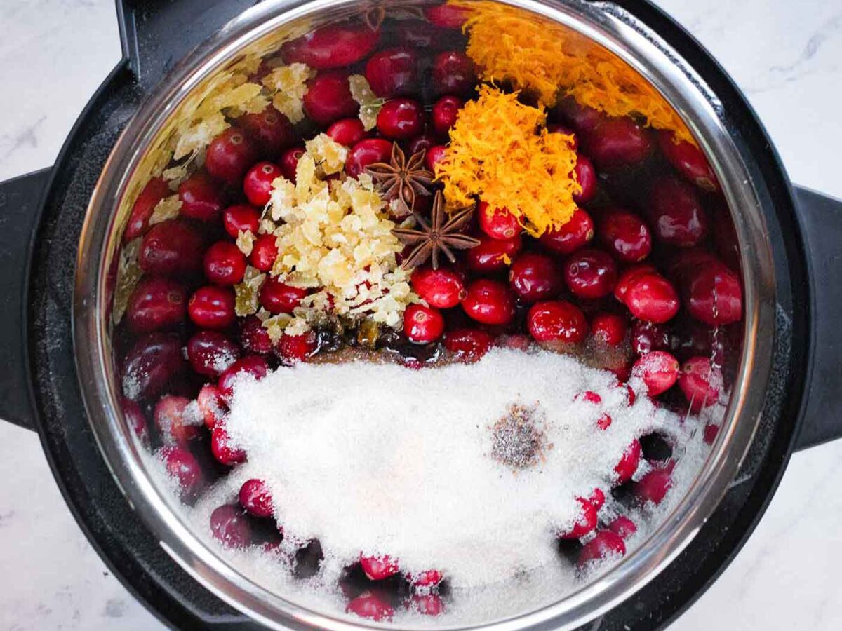 Overhead view of Spiced Cranberry Sauce ingredients in the Instant Pot, ready to cook.