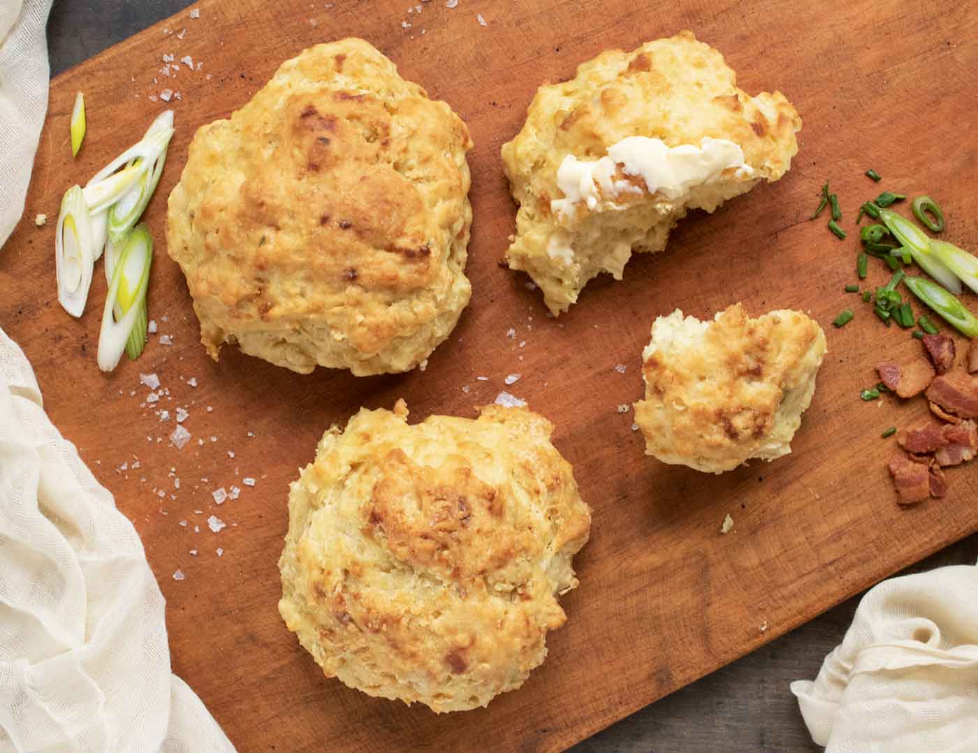 Three Irish Soda Bread Biscuits on a wooden serving board.
