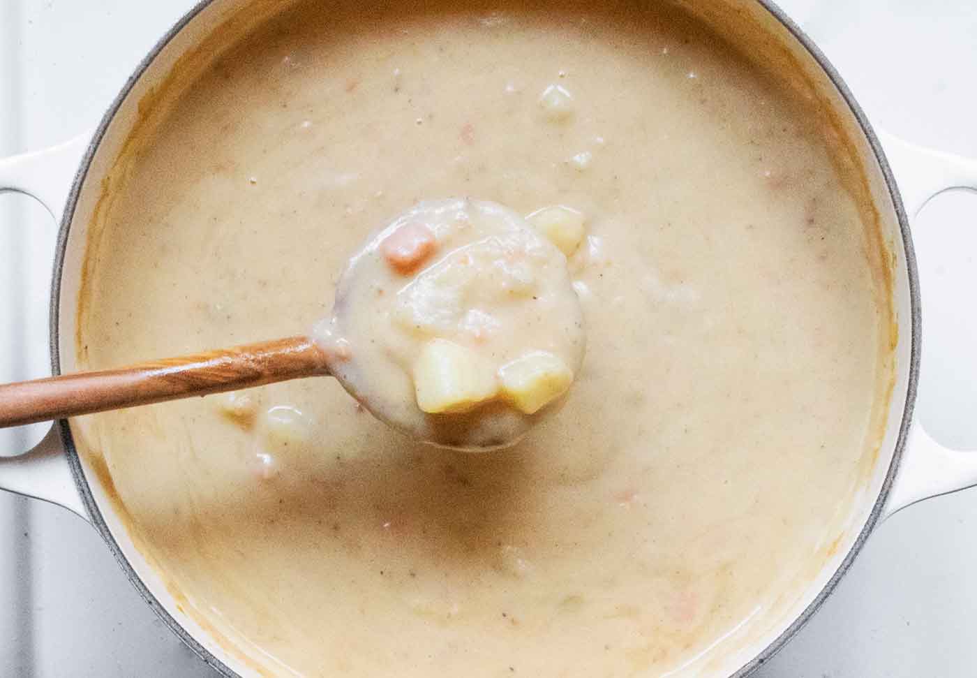A spoon holding a scoop of the finished soup, ready to serve.