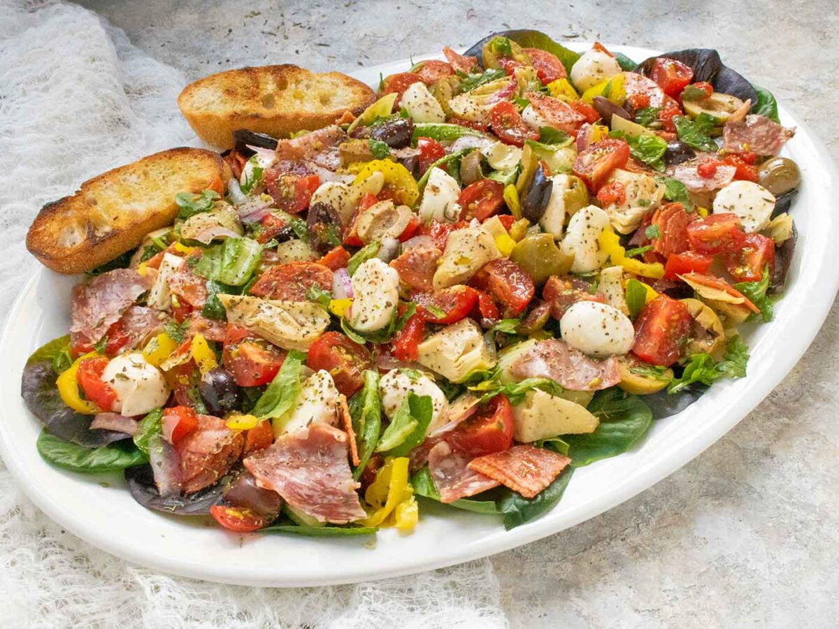 Side angled view of a platter of Italian Antipasto Salad.