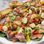 Side view of Italian Antipasto Salad on a plate.
