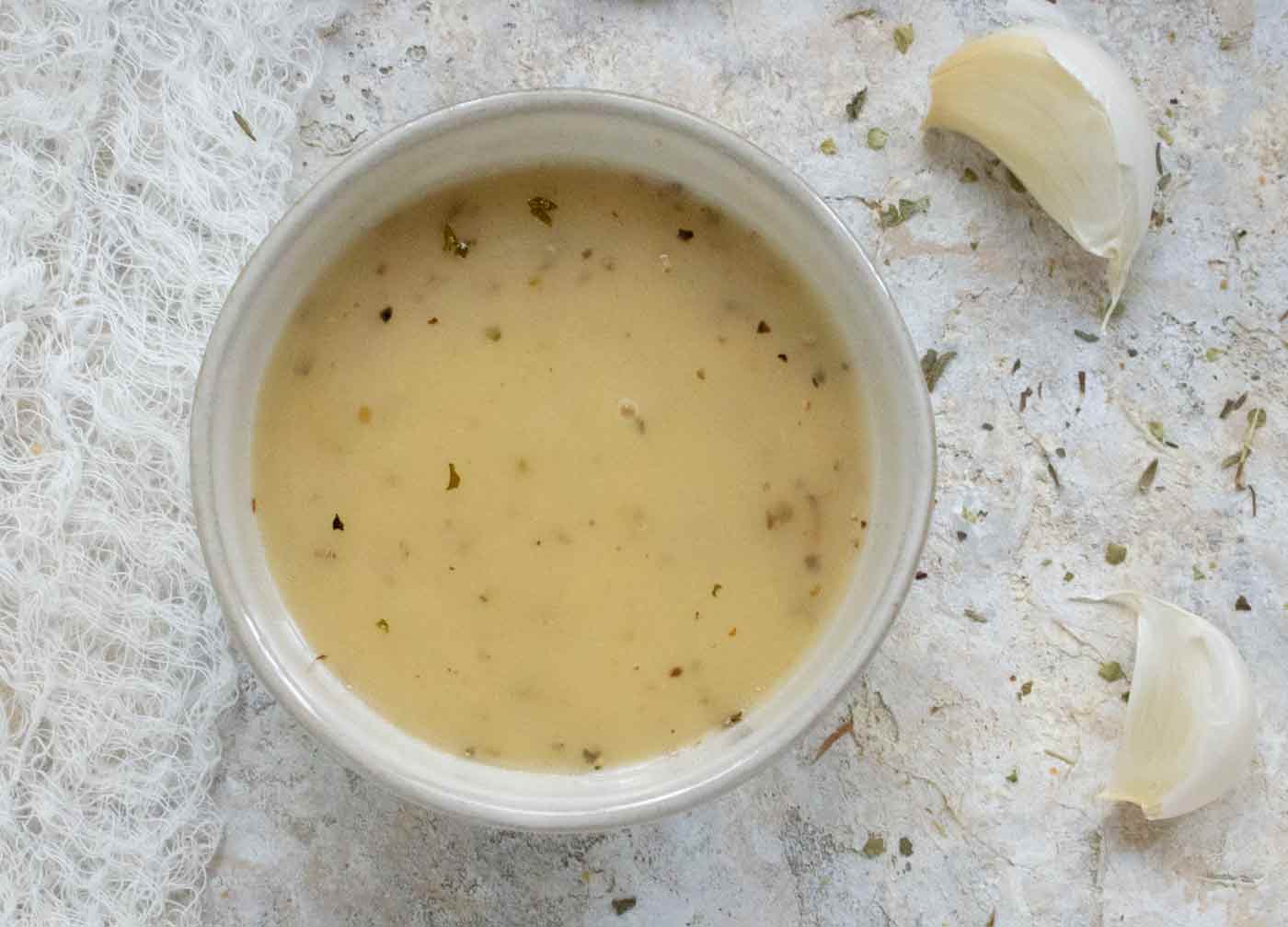 Overhead view of a small bowl of salad dressing.