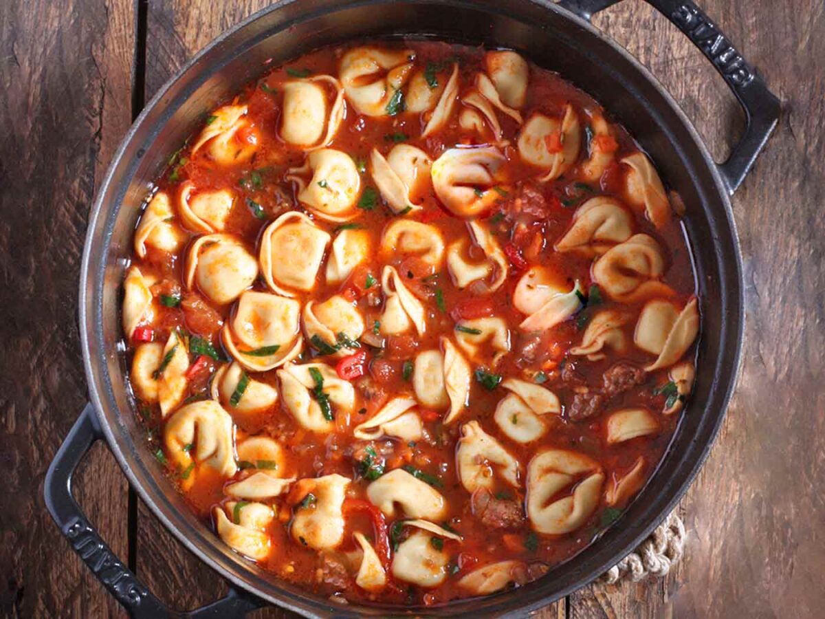 Overhead view of Italian Tortellini Soup in a Dutch oven.