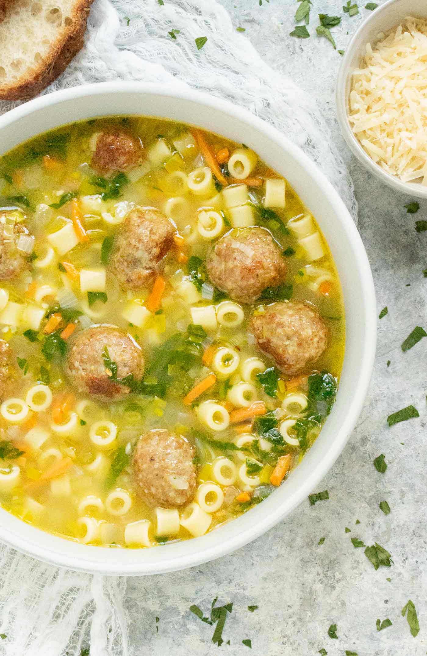 Close-up and 3/4ths view of a bowl of Wedding Soup.