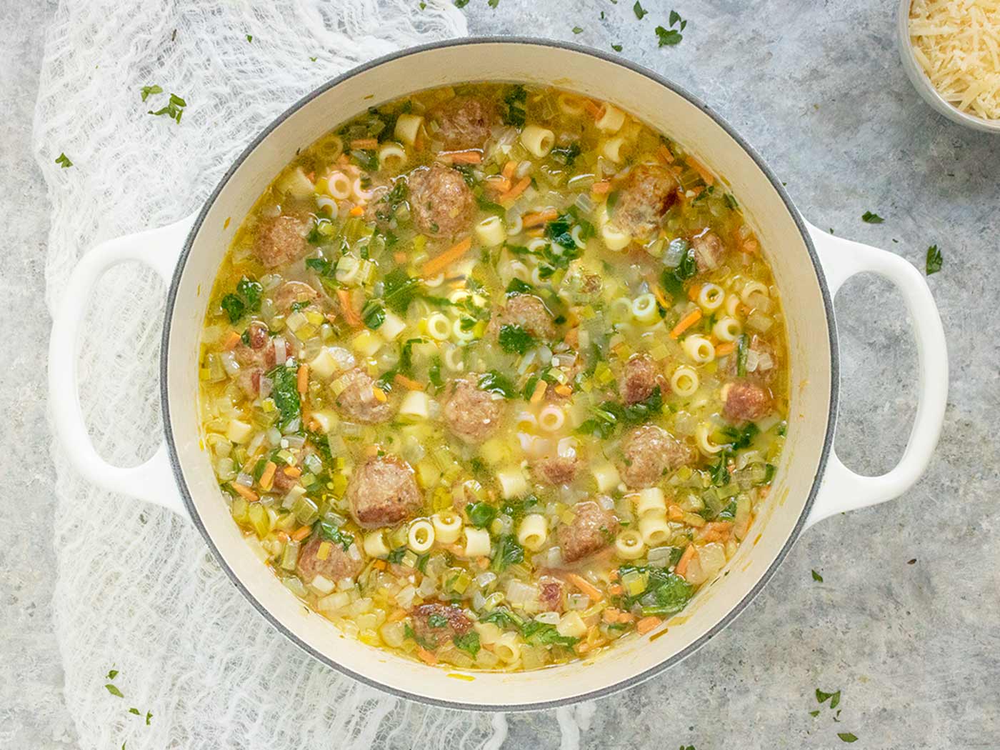 Italian Wedding Soup in a large white Dutch oven.
