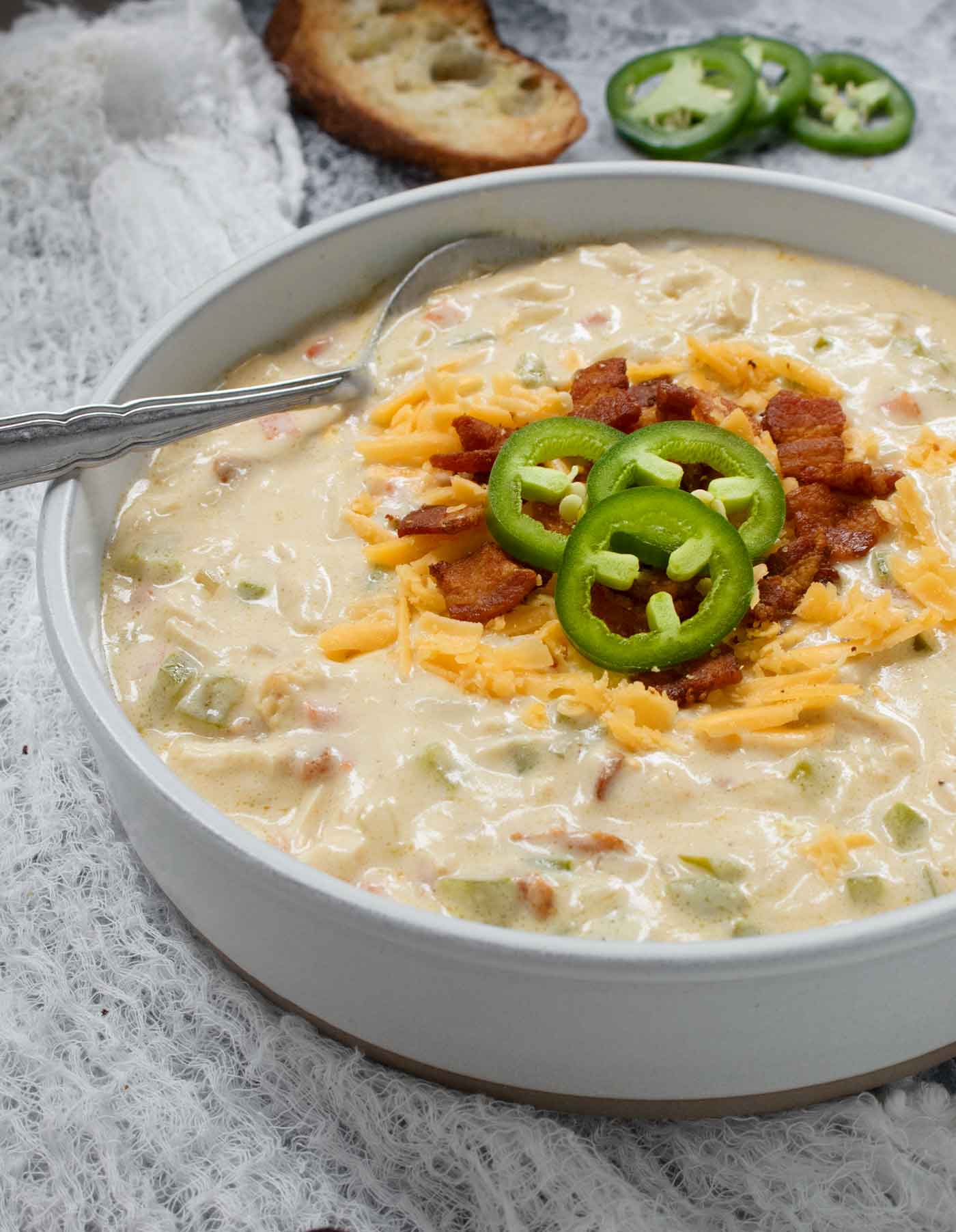 Side-angled view of a bowl of Jalapeno Popper Chicken Soup.