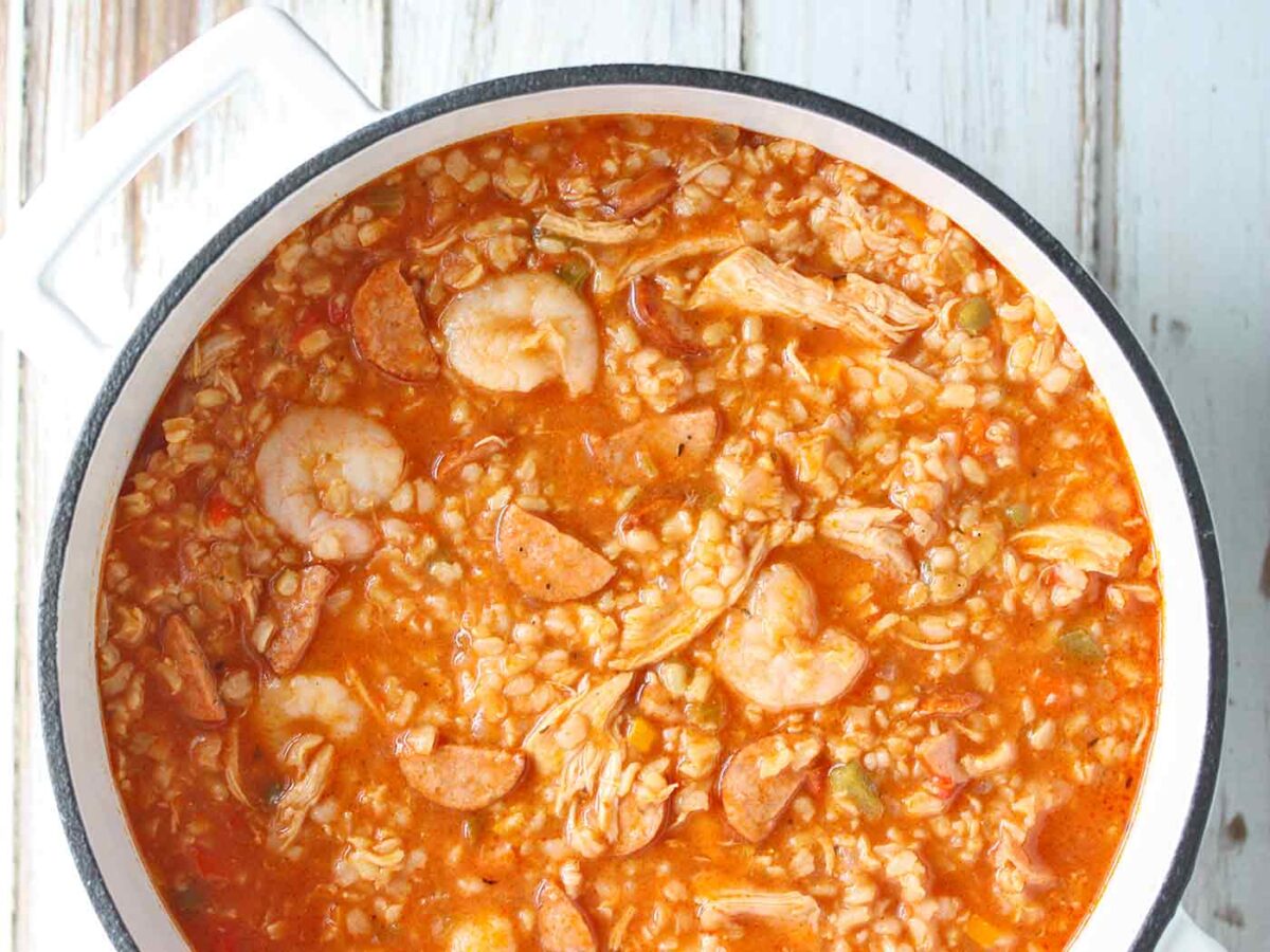 Overhead view of Jambalaya Soup in a white Dutch oven.