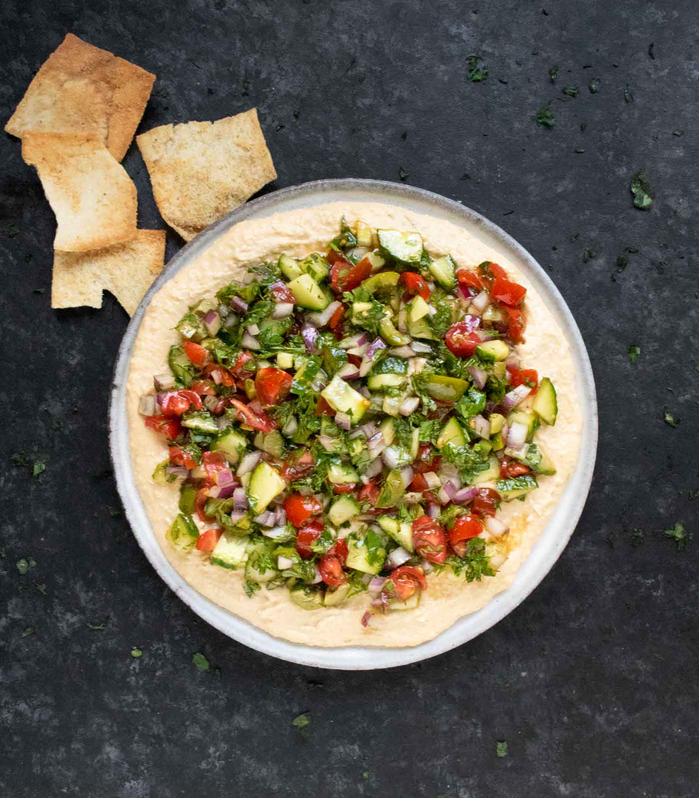Layered Veggies & Hummus assembled and ready to serve, with pita chips on the side.