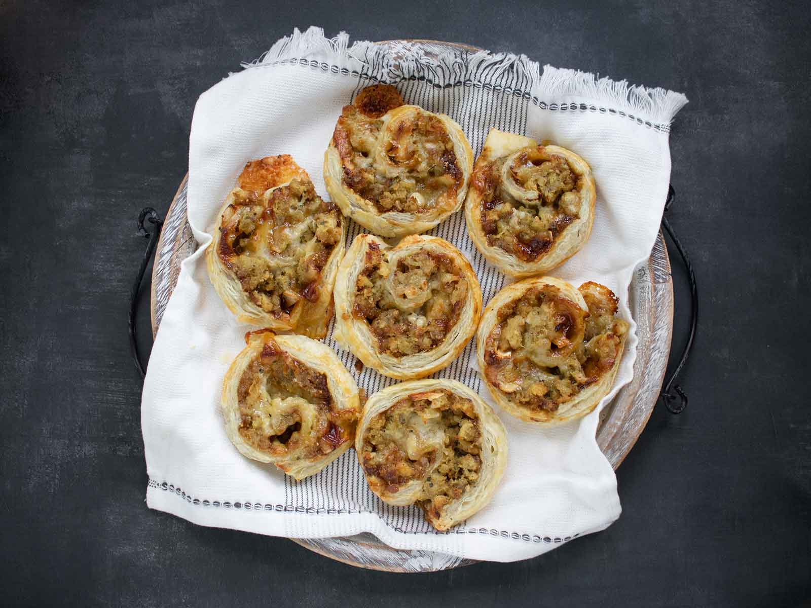 Overhead view of Leftover Stuffing Pinwheels on a serving tray.