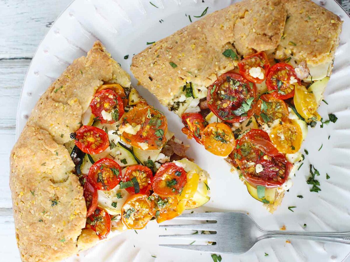 Two slices of Loaded Tomato Galette on a white plate.