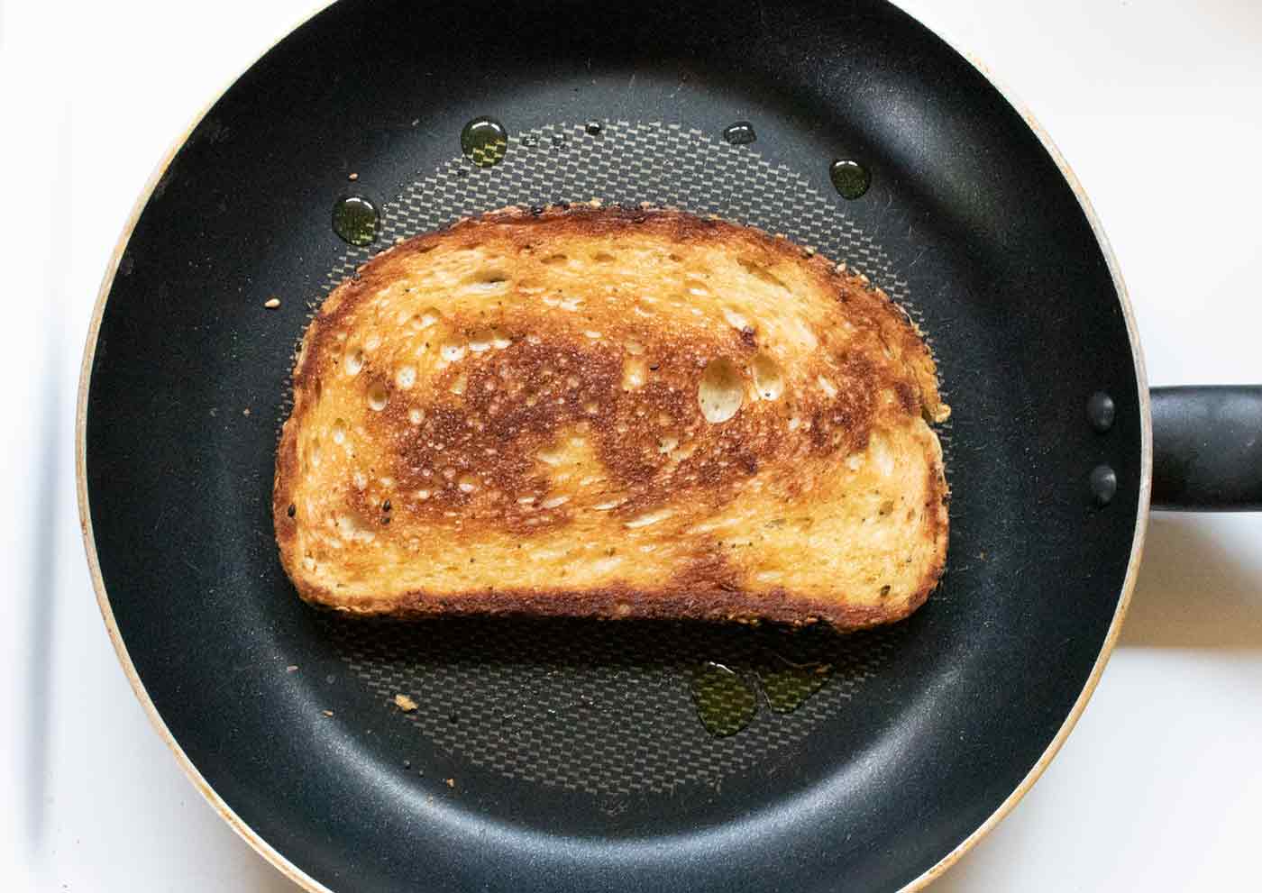 Sourdough bread frying in a skillet.