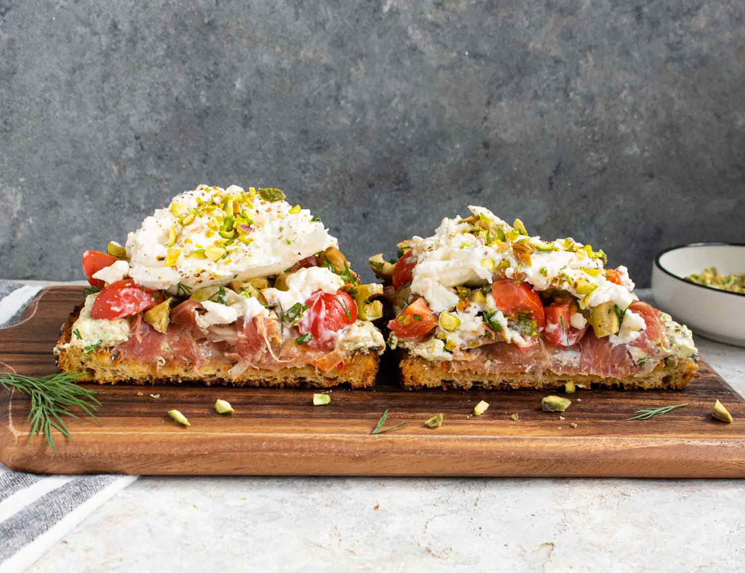 Mediterranean Burrata Fried Toast with Creamy Pesto sliced in half, showing the stacked insides.