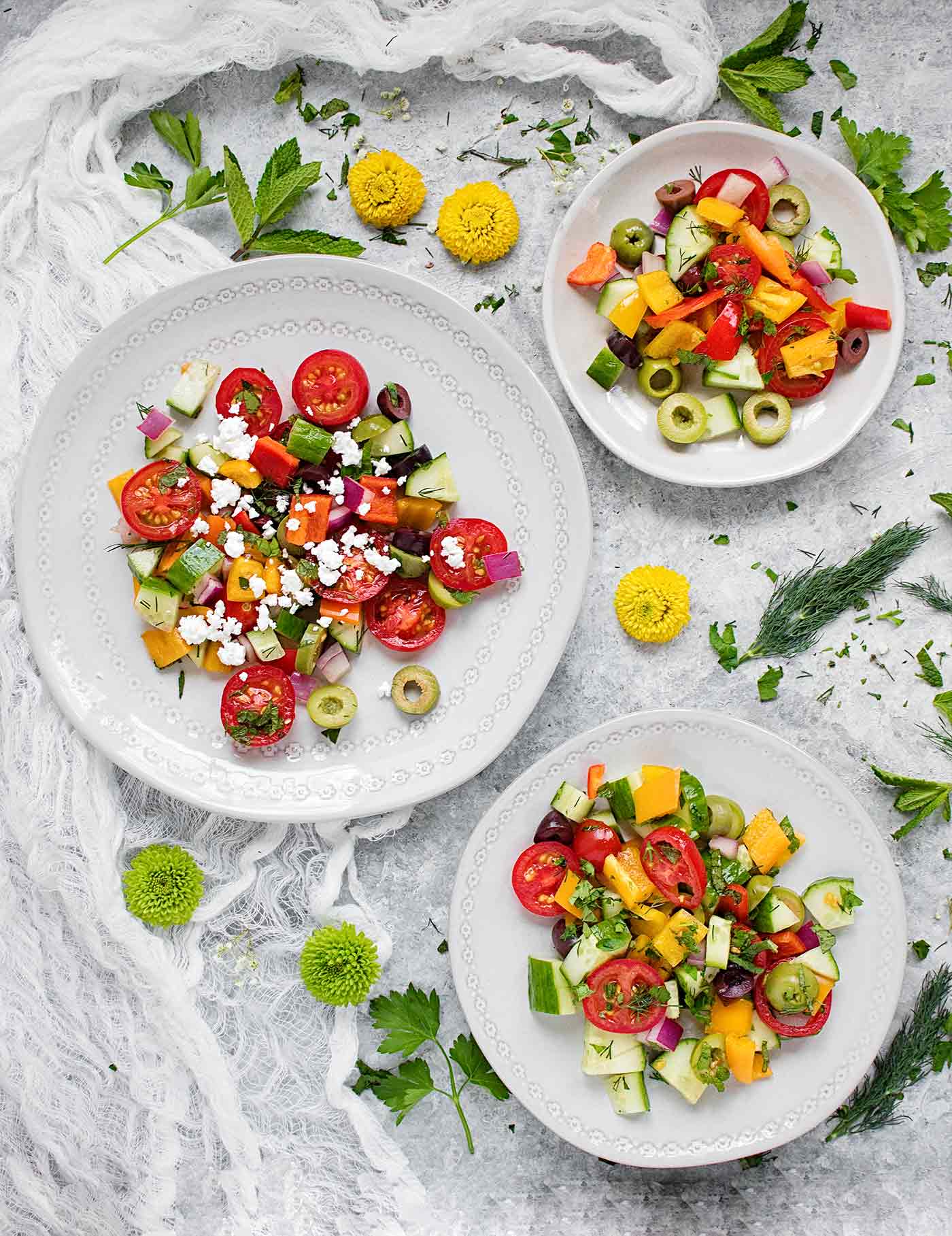 Three plates filled with Mediterranean Salad