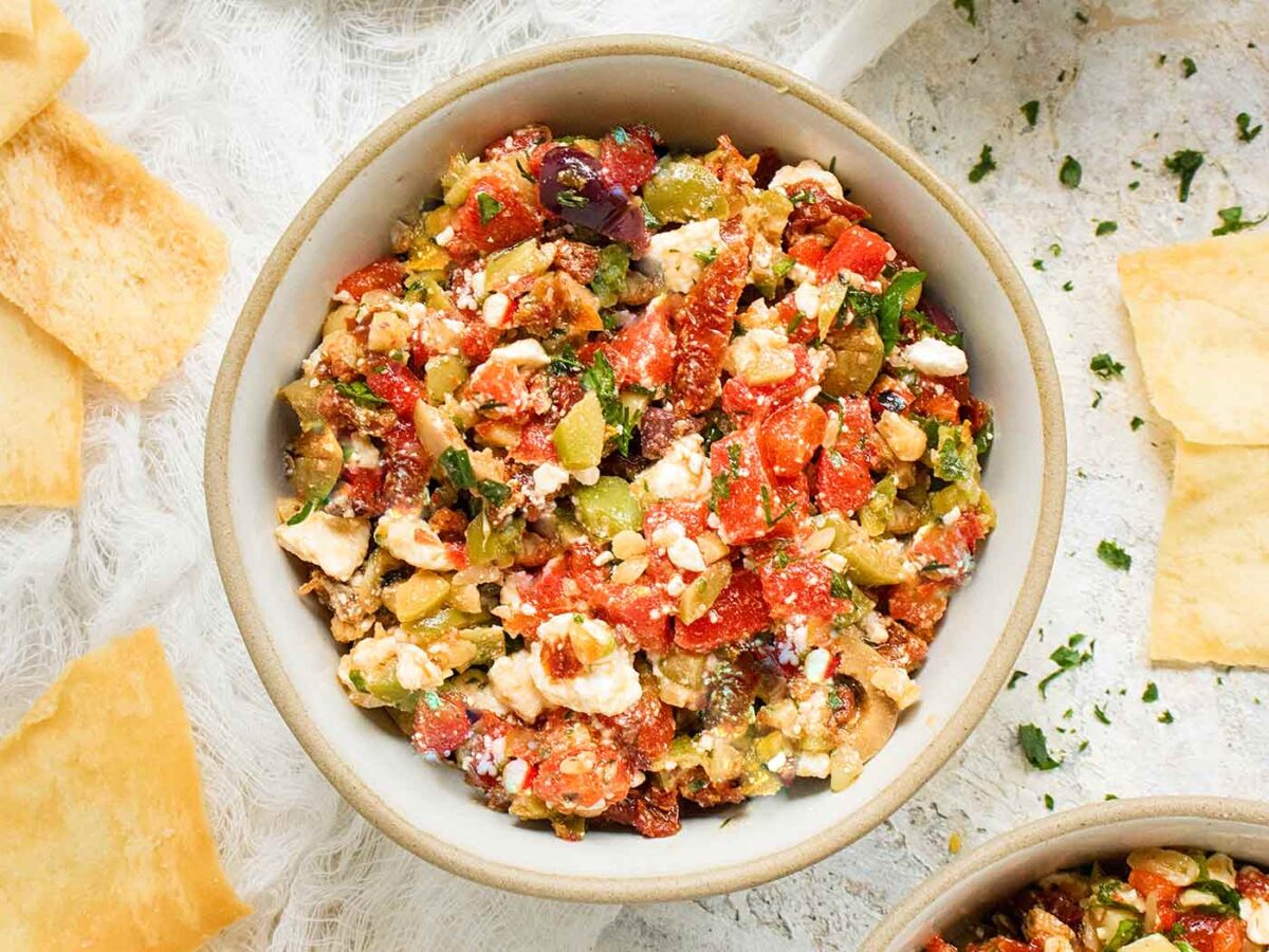 Overhead view of Mediterranean Salsa in a bowl with a side of pita chips.