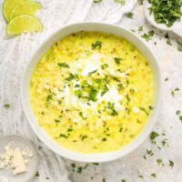 A bowl of corn soup on a white background