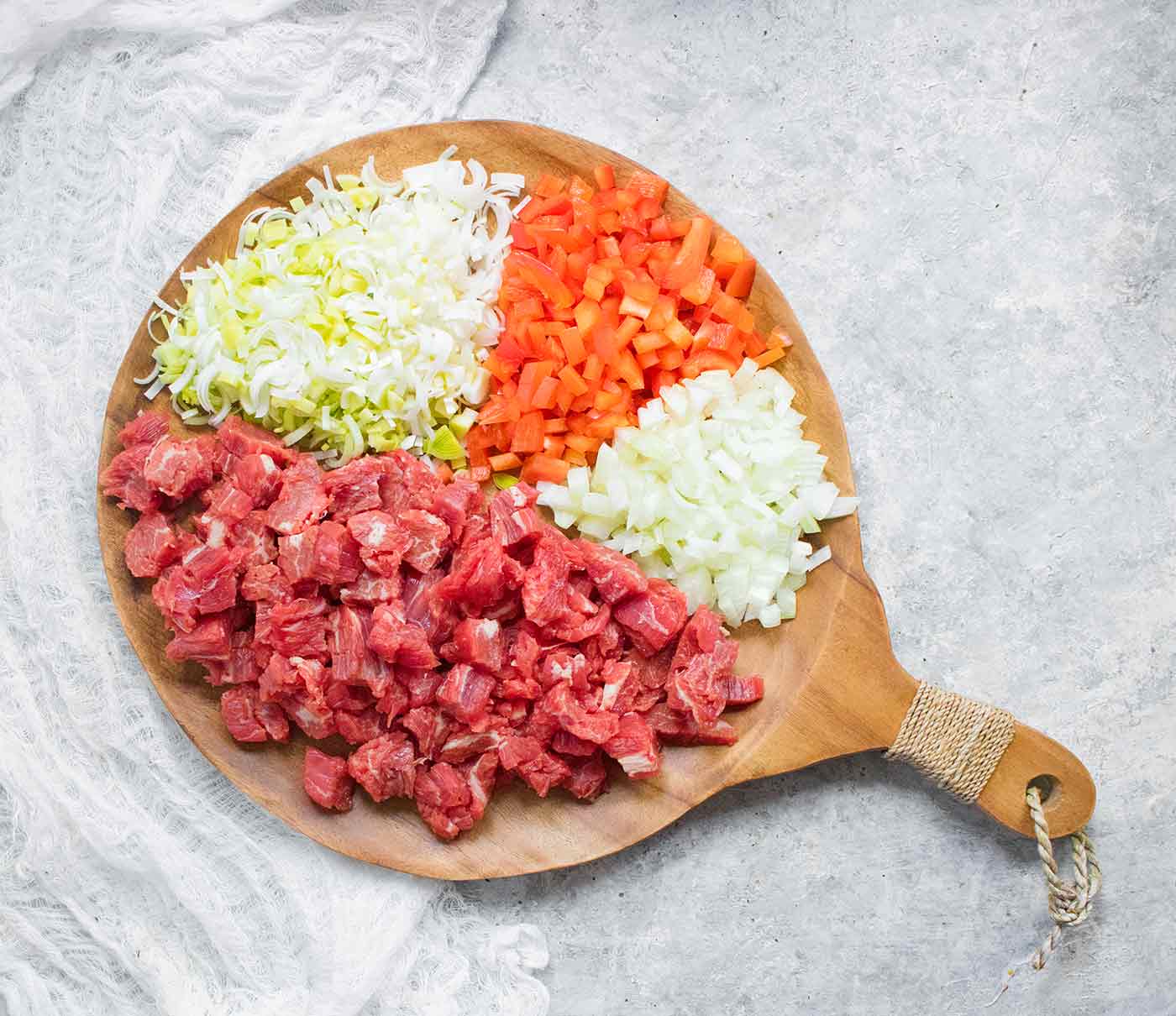 Ingredients for Mongolian Beef Soup on a round wooden serving board