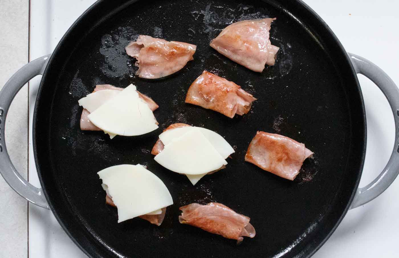 Melting the cheese on the crispy mortadella.