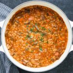 Mushroom Barley Soup in a white Dutch oven.