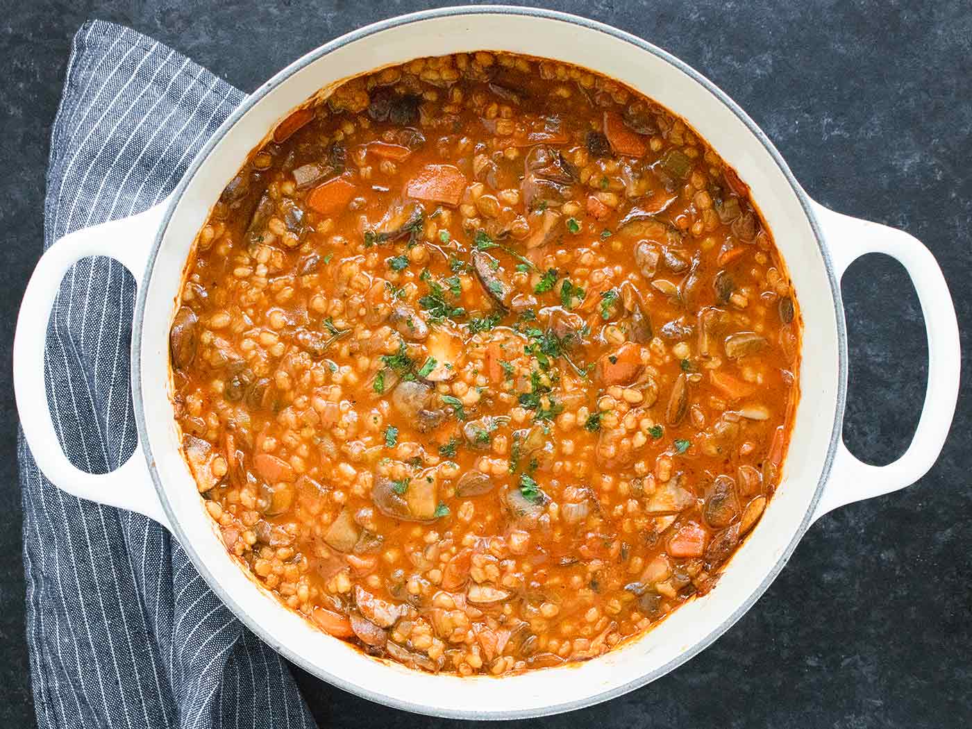 Mushroom Barley Soup in a white Dutch oven.
