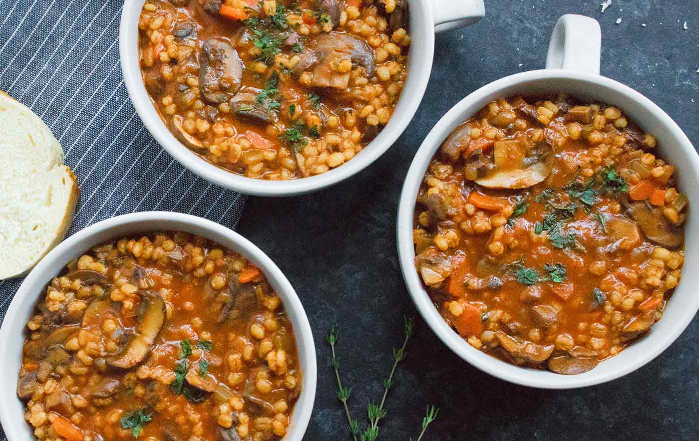 Three bowls of Mushroom Barley Soup, ready to serve.