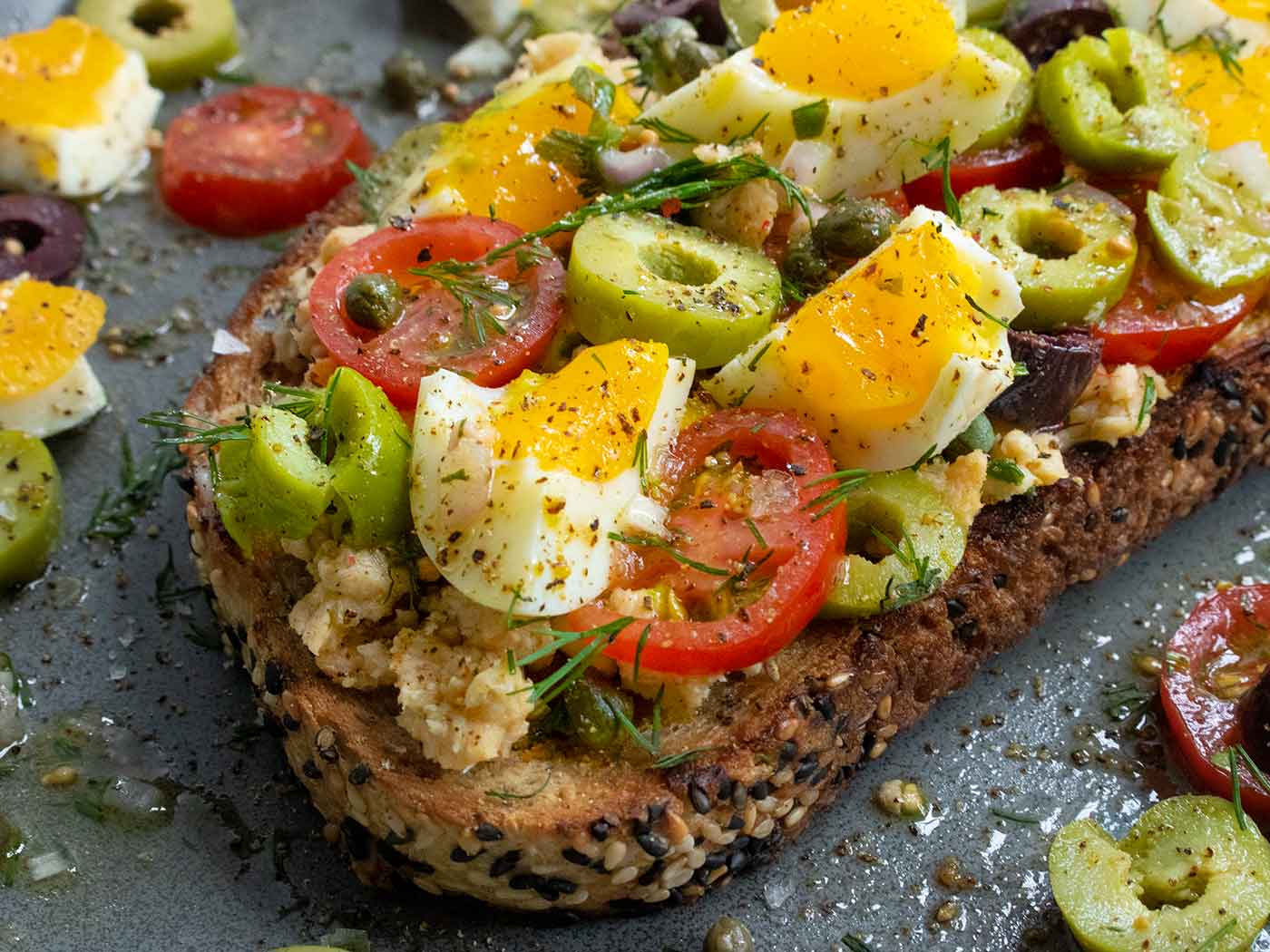 Angled, side view of Nicoise Fried Toast with Jammy Eggs.