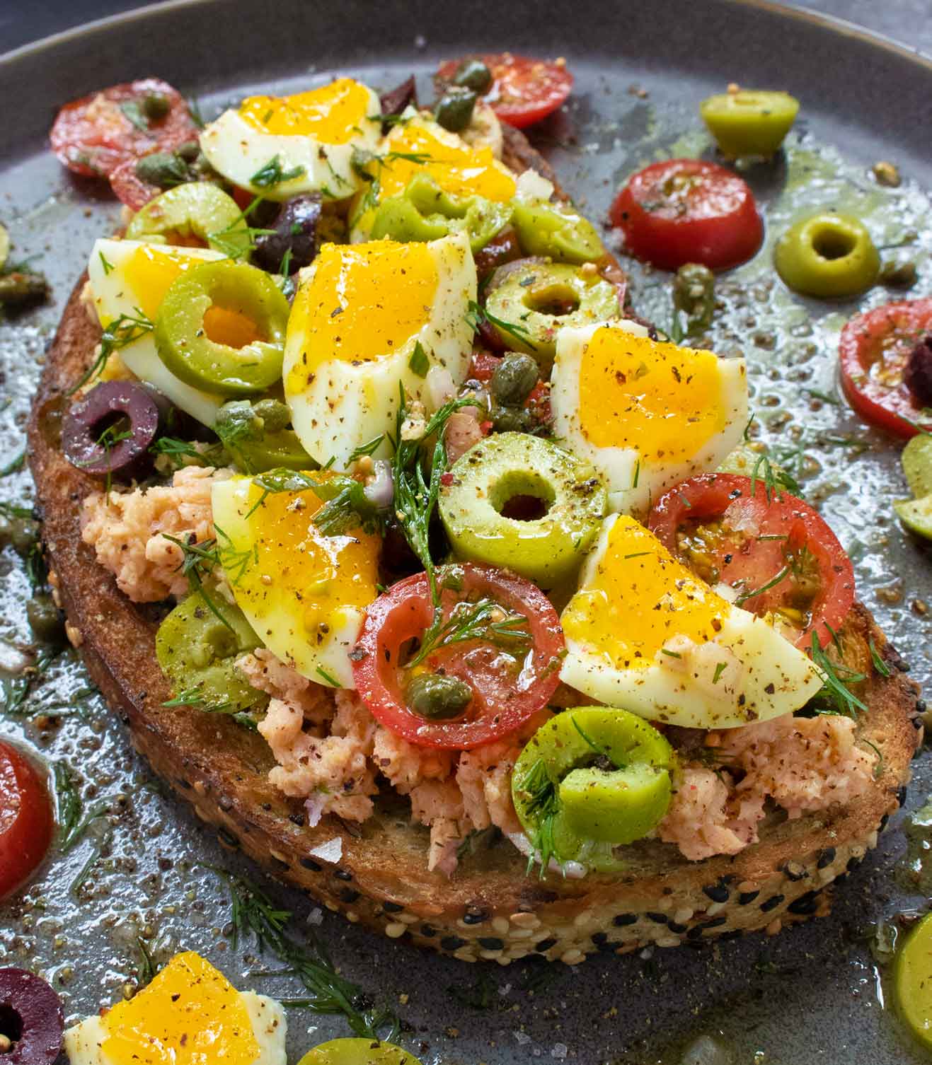 A front angled view of Nicoise Fried Toast with Jammy Eggs.