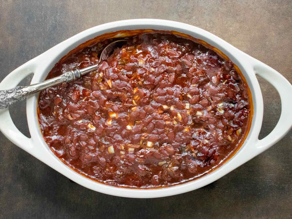 Overhead view of Oven-baked Canned Baked Beans in a white baking dish.