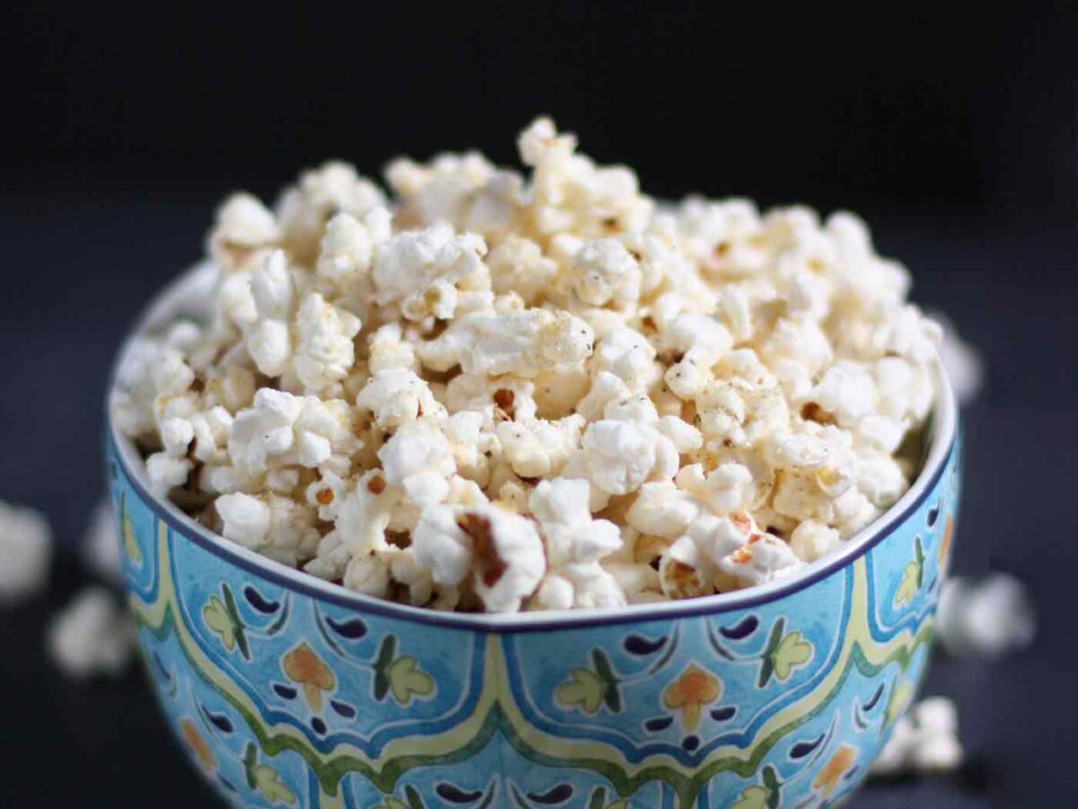 Parmageddon Popcorn heaped in a blue serving bowl.
