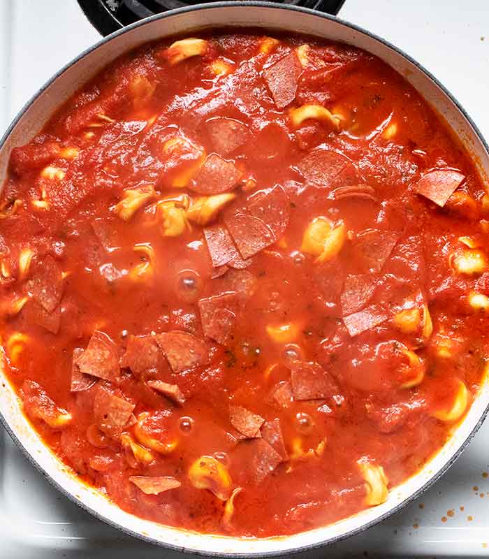 Cooking the tortellini in the marinara sauce.