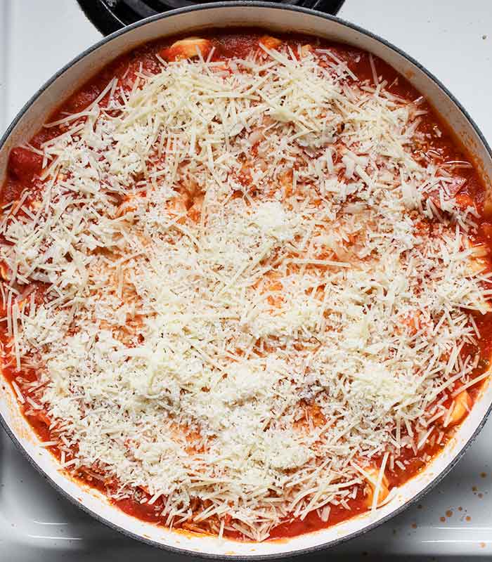 Sprinkle the cheeses over the marinara sauce.