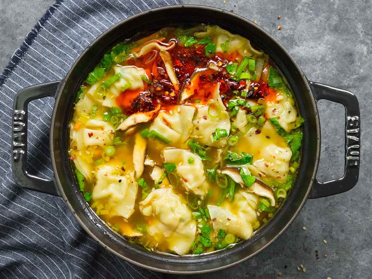 Overhead view of Potsticker Soup in a black Dutch oven.