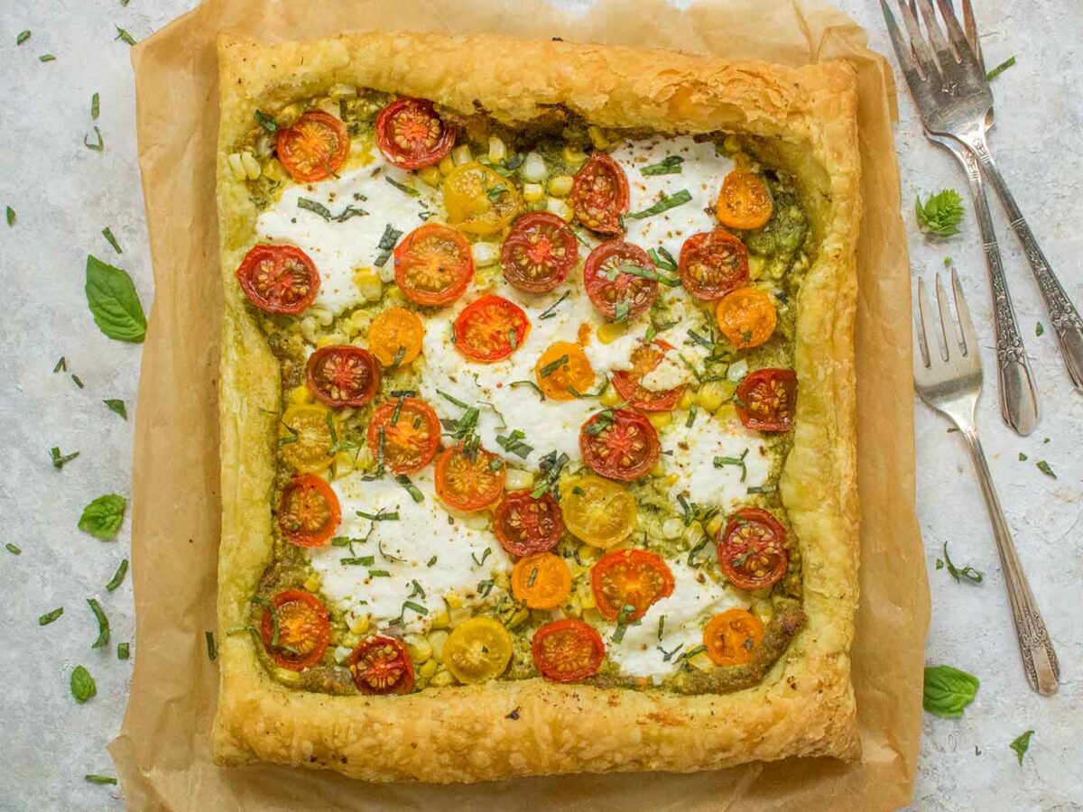 Overhead view of Puff Pastry Tomato Tart on a piece of parchment paper.