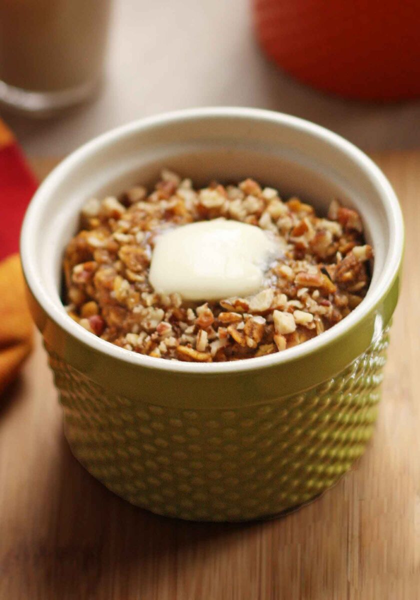 Baked Pumpkin Pie Oatmeal in a green ramekin, ready to eat.