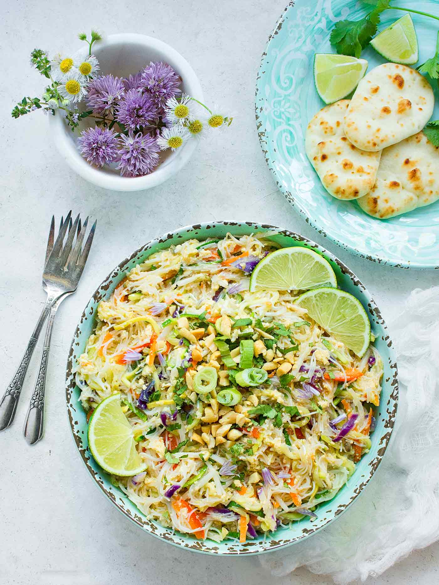 A bowl of Rainbow Pad Thai with a side of mini naans