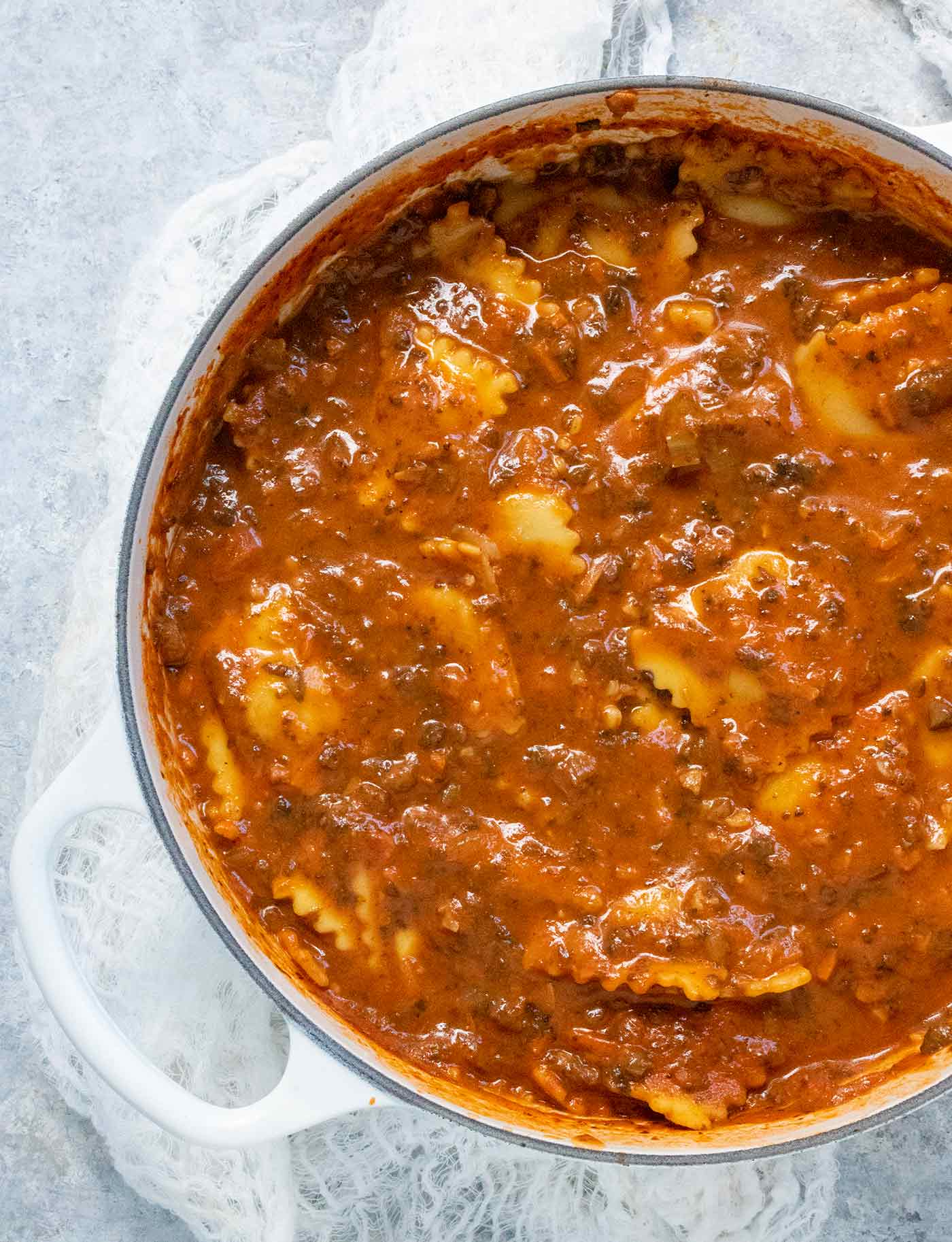 Ravioli Soup in a large white Dutch oven.