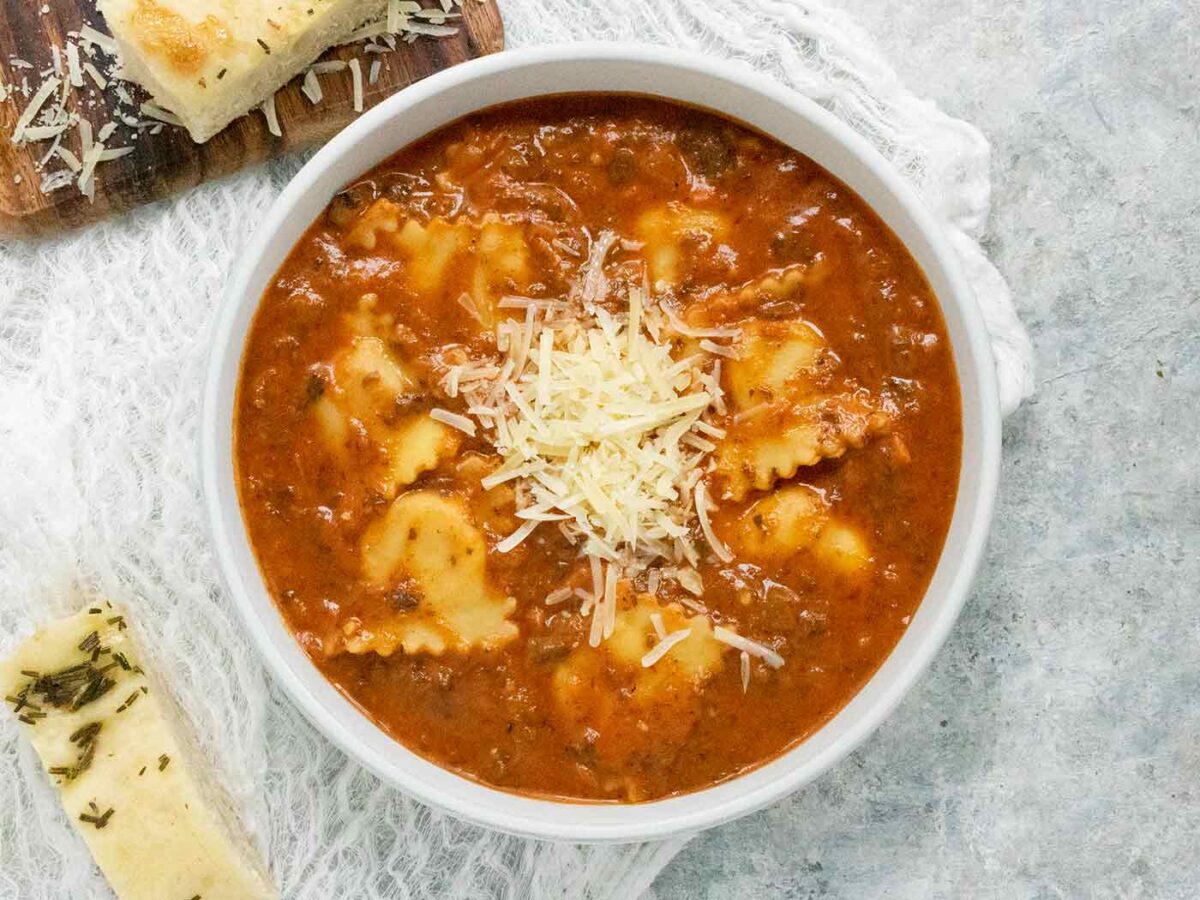 Overhead view of Ravioli Soup in a white bowl.