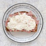 Overhead view of a Reuben Fried Toast on a gray plate.