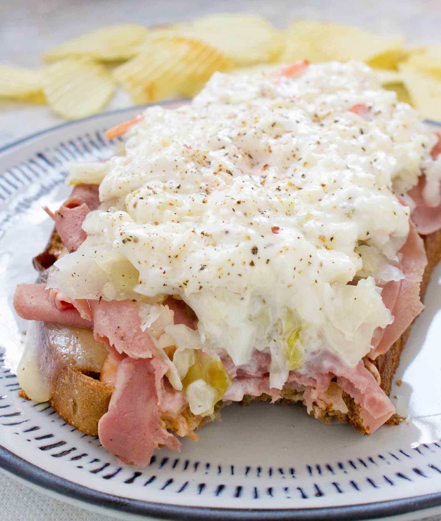 Close up of Fried Reuben Toast with a bite taken out of it.