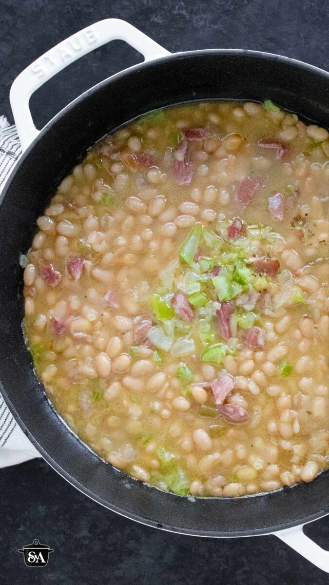 Pinterest pin image for Senate Bean Soup, featuring an overhead view of the soup in a Dutch oven.